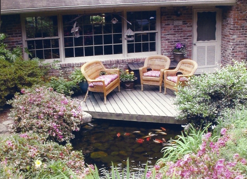 Deck at front door overlooks pond